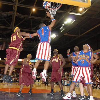 Harlem Globetrotter player making a basket during a basketball game.