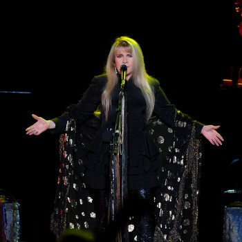 Stevie Nicks singing on stage during a concert.