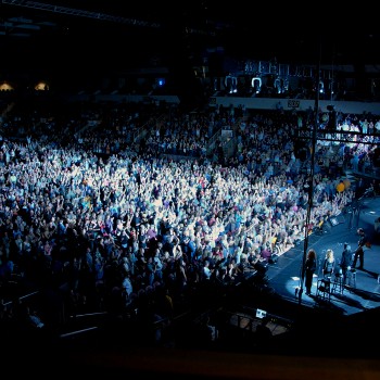 View of the concert crowd looking towards the performer on stage.