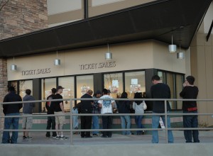 Arena box office with customers standing outside purchasing tickets.